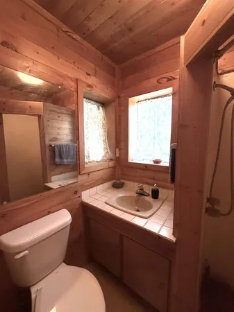 a bathroom with a sink and mirror with toilet