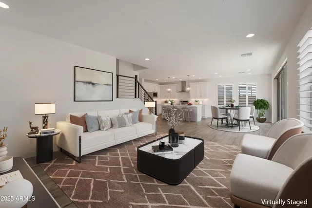 a living room with furniture and view of kitchen