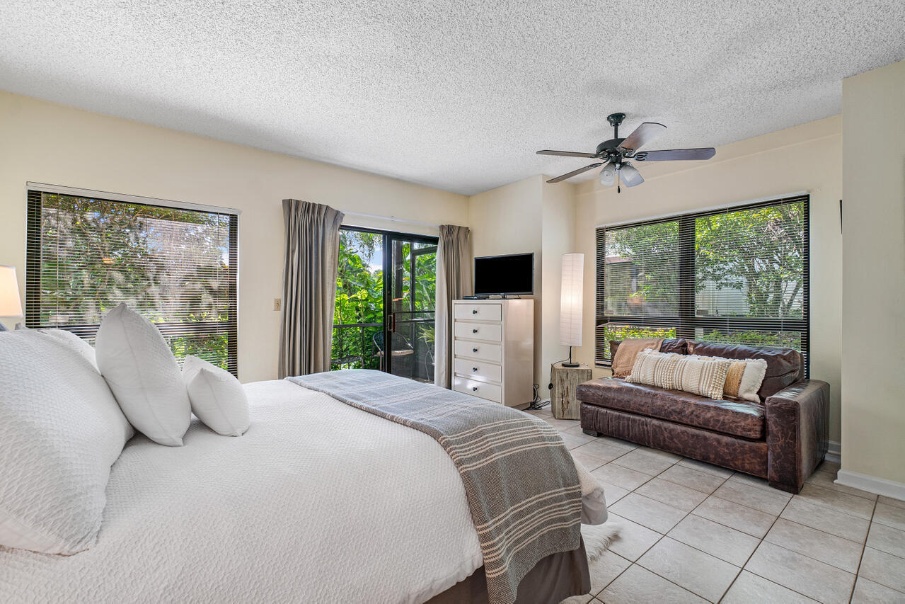 13334 Polo Club Road, Unit 238 Wellington, FL 33414 - Photo 11 of 13 a spacious bedroom with a bed and a couch