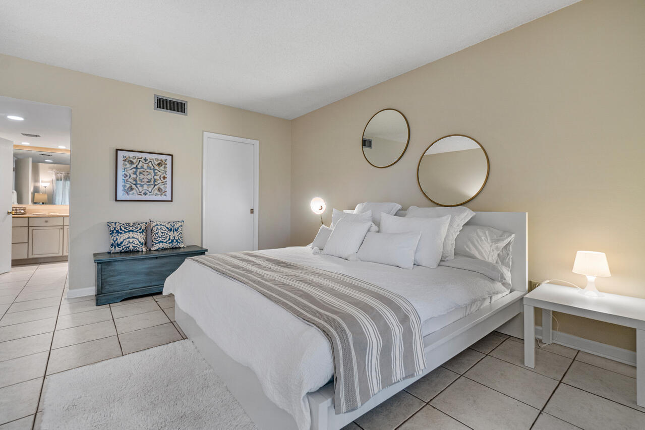 13334 Polo Club Road, Unit 238 Wellington, FL 33414 - Photo 6 of 13 a bedroom with a large bed and a lamp