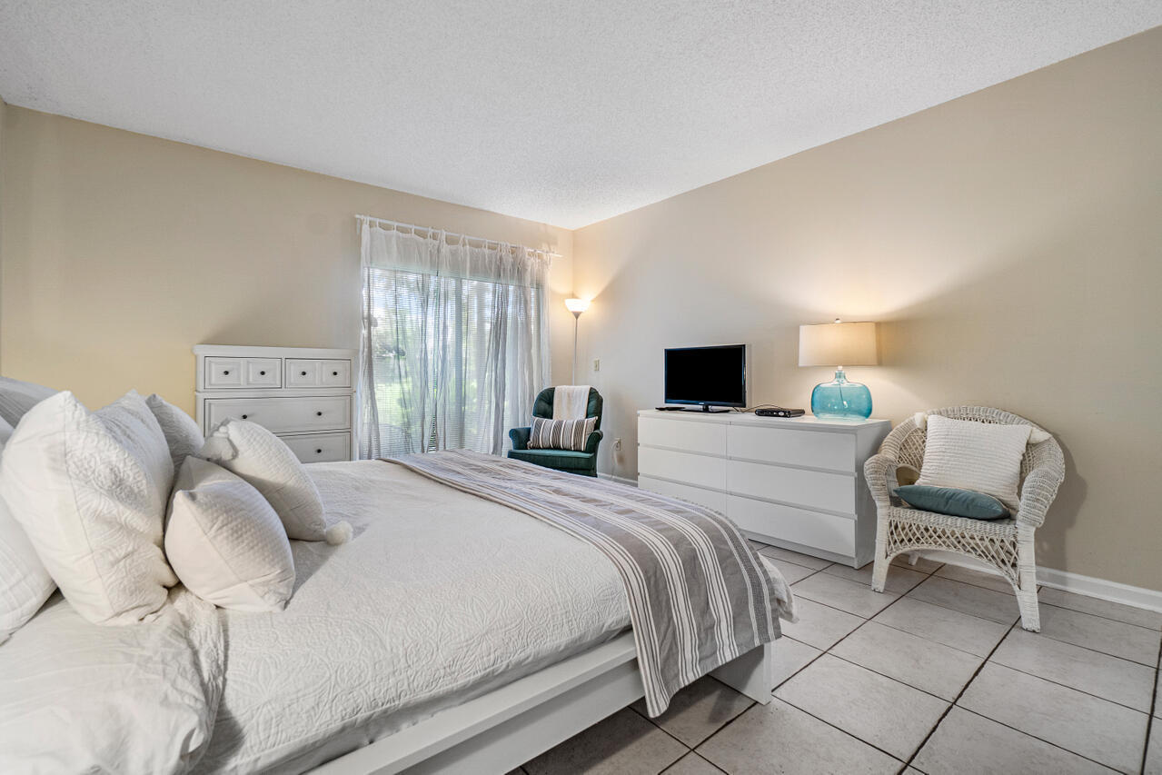 13334 Polo Club Road, Unit 238 Wellington, FL 33414 - Photo 7 of 13 a bedroom with a bed and a television