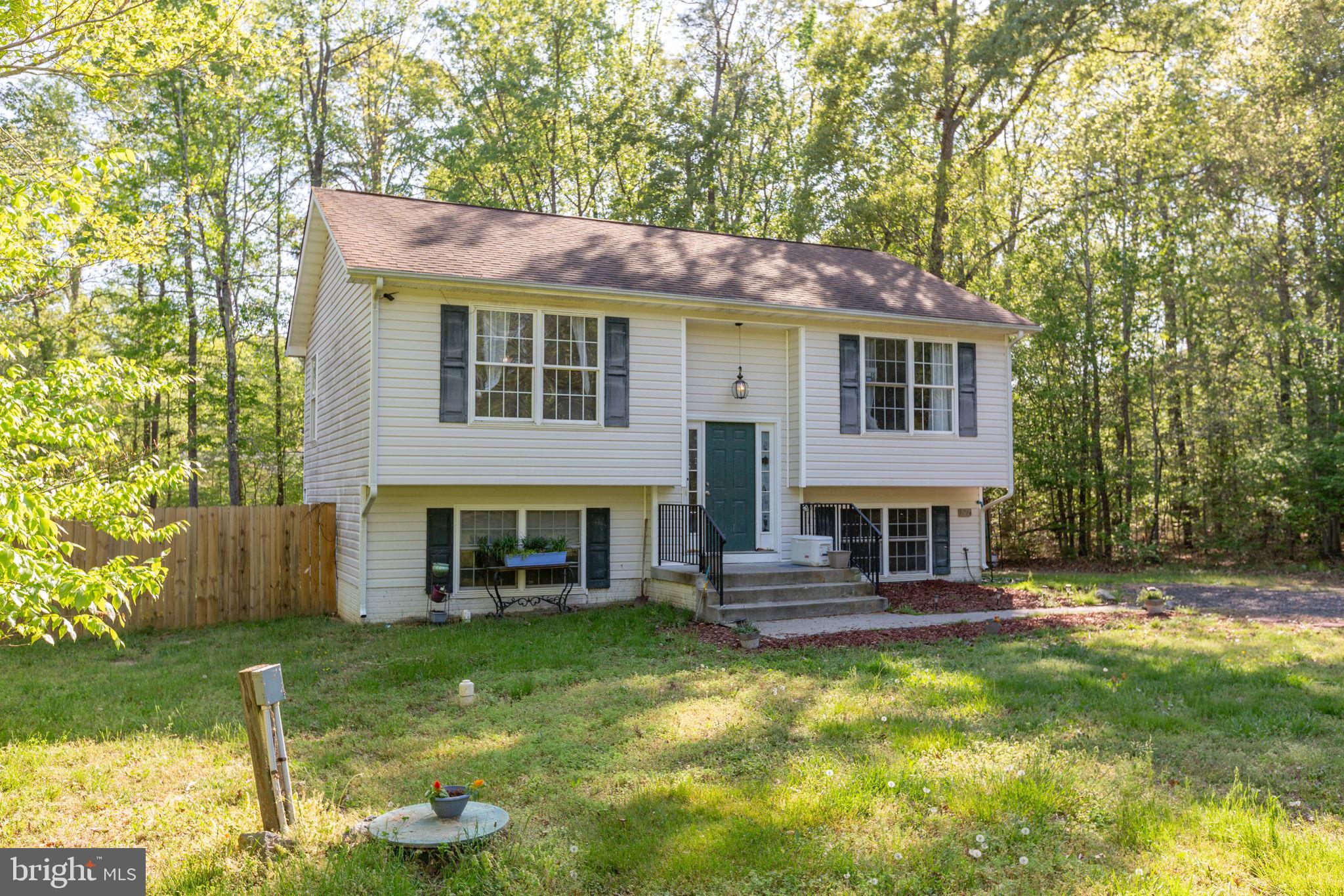 877 Campers Lane Ruther Glen, VA 22546 - Photo 1 of 13 a view of a house with a yard porch and sitting area
