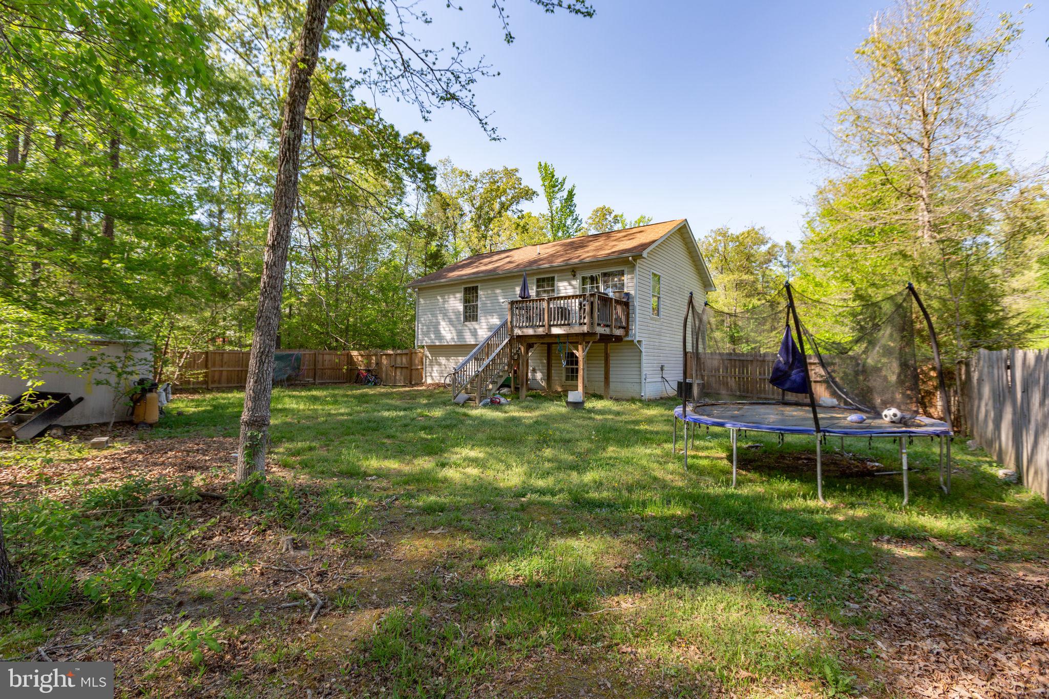 877 Campers Lane Ruther Glen, VA 22546 - Photo 11 of 13 a view of a house with a yard