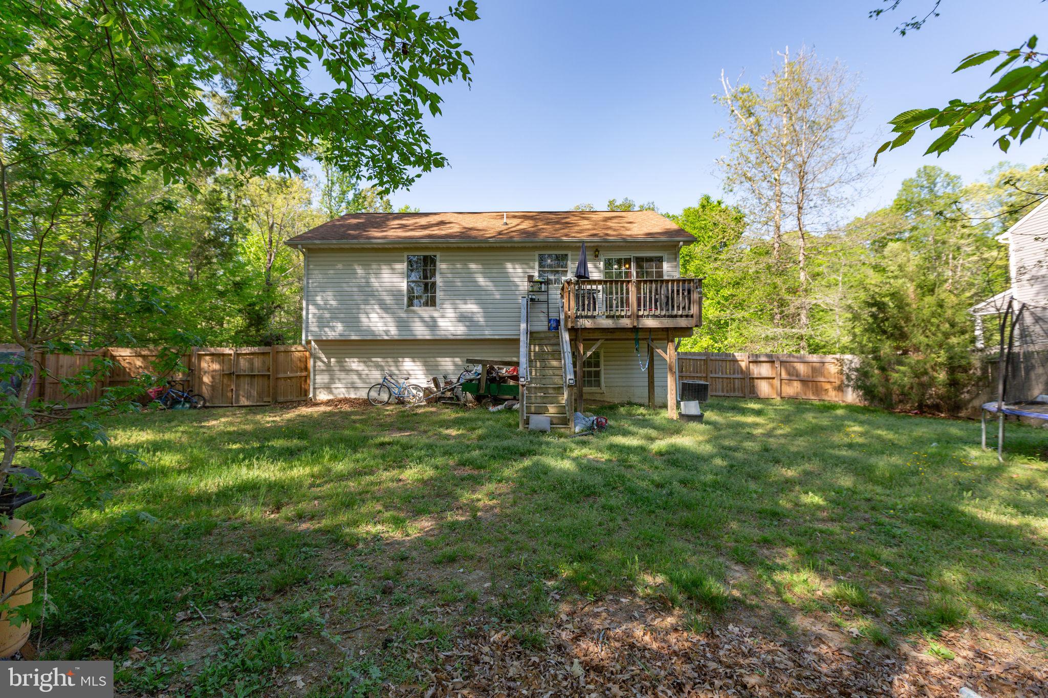 877 Campers Lane Ruther Glen, VA 22546 - Photo 12 of 13 a view of a big house with a big yard plants and large trees