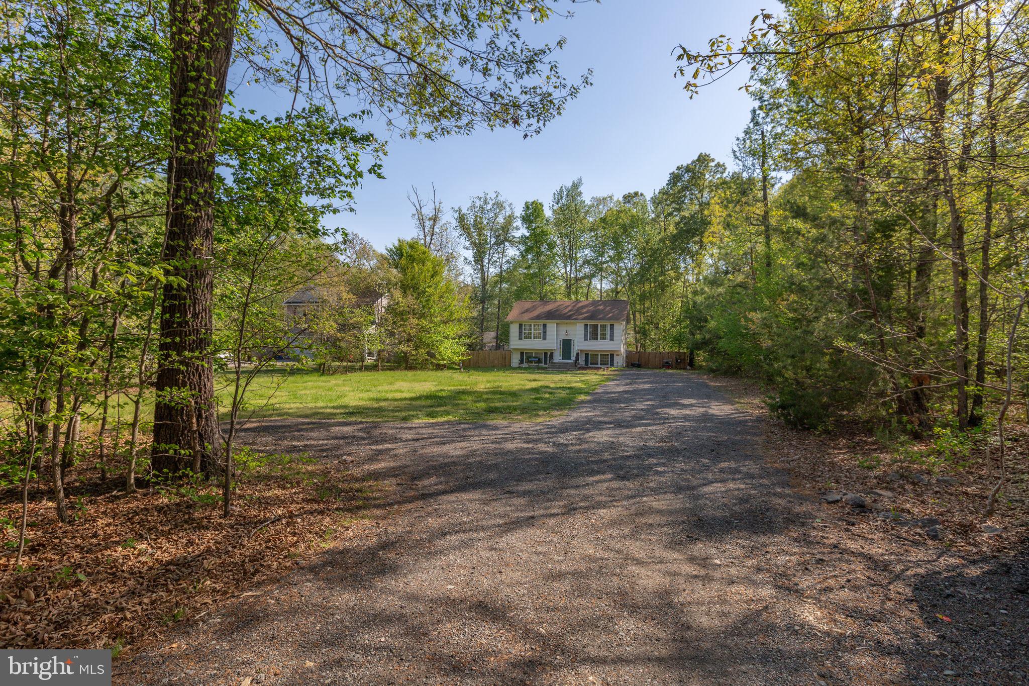 877 Campers Lane Ruther Glen, VA 22546 - Photo 13 of 13 a view of a house with a yard