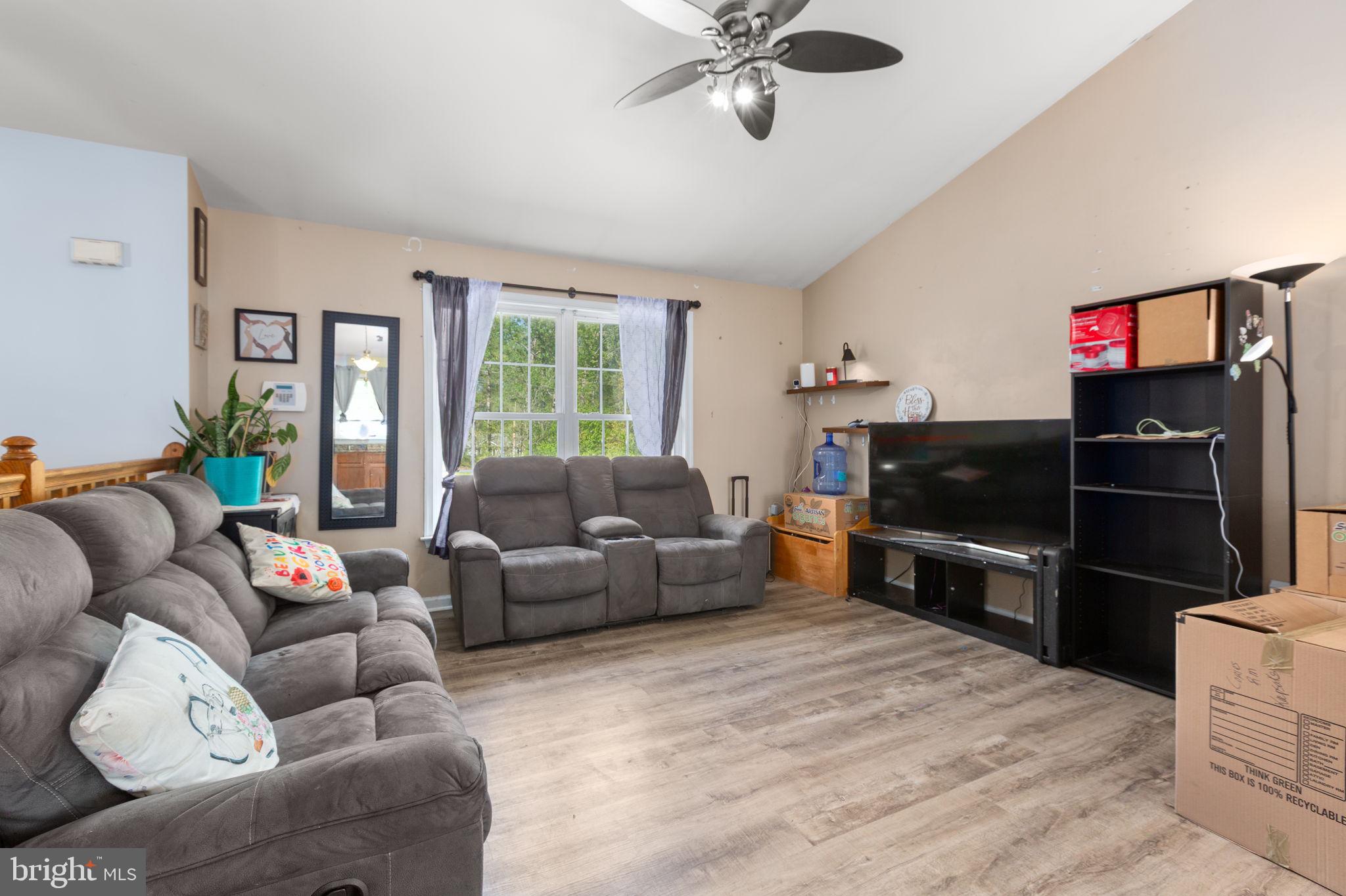 877 Campers Lane Ruther Glen, VA 22546 - Photo 2 of 13 a living room with furniture a flat screen tv and a refrigerator