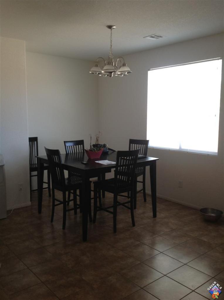 42909 Edson Avenue Lancaster, CA 93536 - Photo 3 of 14 a view of a dining room with furniture and chandelier