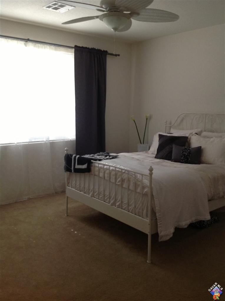 42909 Edson Avenue Lancaster, CA 93536 - Photo 6 of 14 a bedroom with a bed and a window