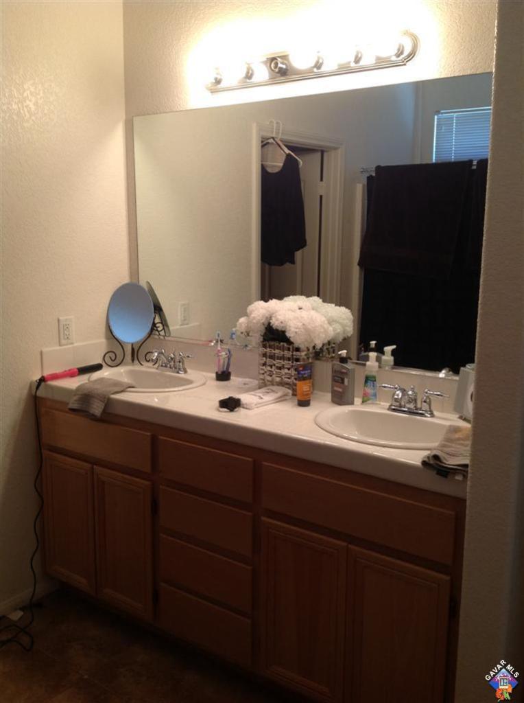 42909 Edson Avenue Lancaster, CA 93536 - Photo 7 of 14 a bathroom with a sink and a mirror