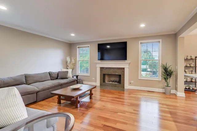 a living room with furniture a flat screen tv and a fireplace