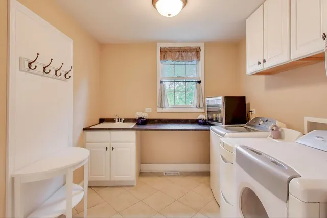 a view of cabinets a sink and a microwave