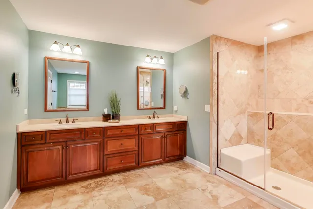 a spacious bathroom with a tub sink mirror and