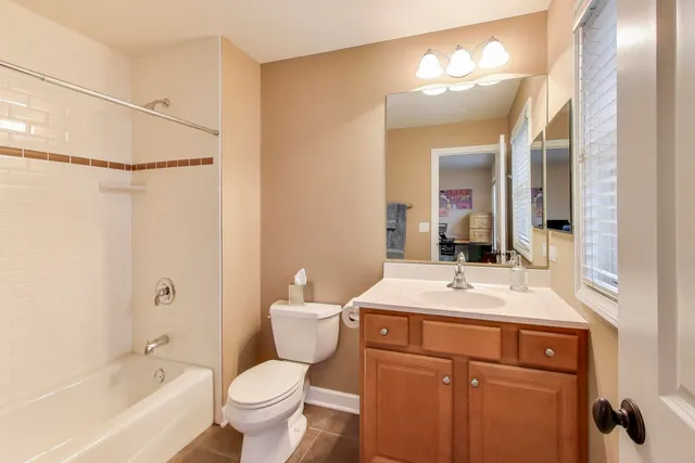 a bathroom with a sink toilet vanity and shower