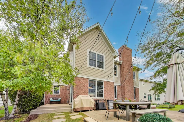 a view of house with backyard and sitting area