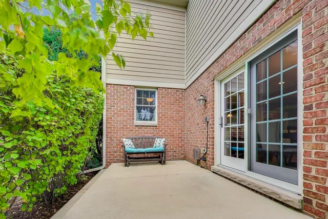 a view of house with backyard sitting area and garden