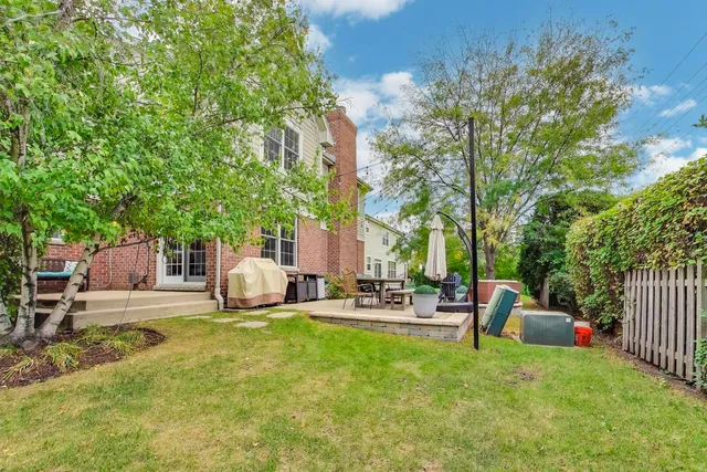 a view of backyard with swimming pool and furniture