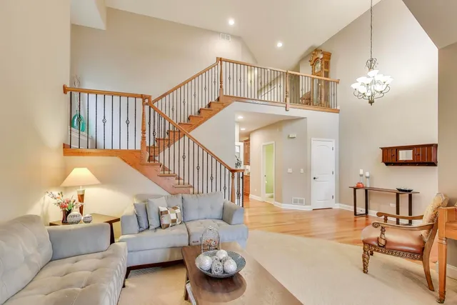 a living room with furniture and a chandelier