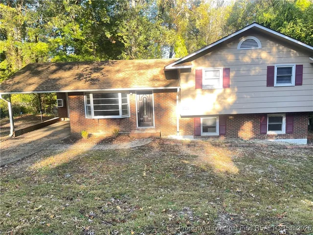 a view of house with backyard