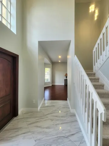 a view of entryway and hall with wooden floor