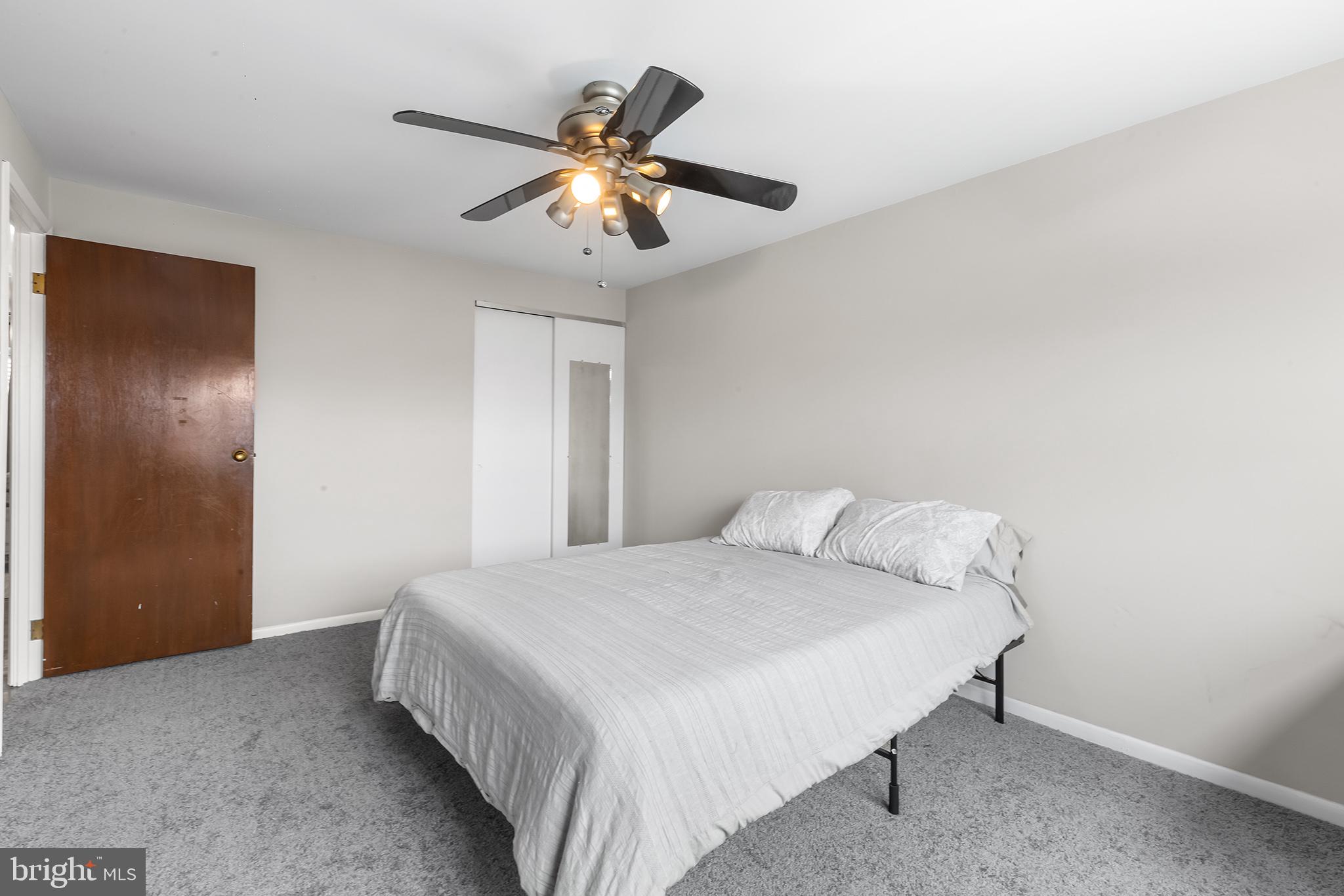 12100 Ranier Road Philadelphia, PA 19154 - Photo 17 of 32 a bedroom with a large bed and a chandelier