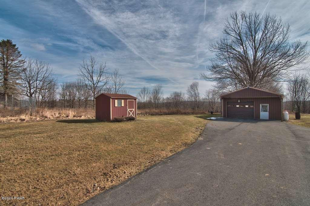 682 Stock Farm Road Lake Ariel, PA 18436 - Photo 62 of 78 a front view of a house with a yard and tree s