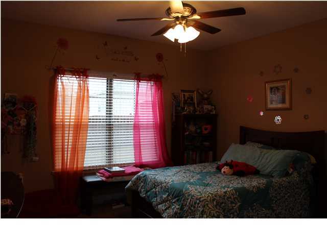 4601 Hermosa Road Crestview, FL 32539 - Photo 22 of 36 a black and white bed in a bedroom next to a window