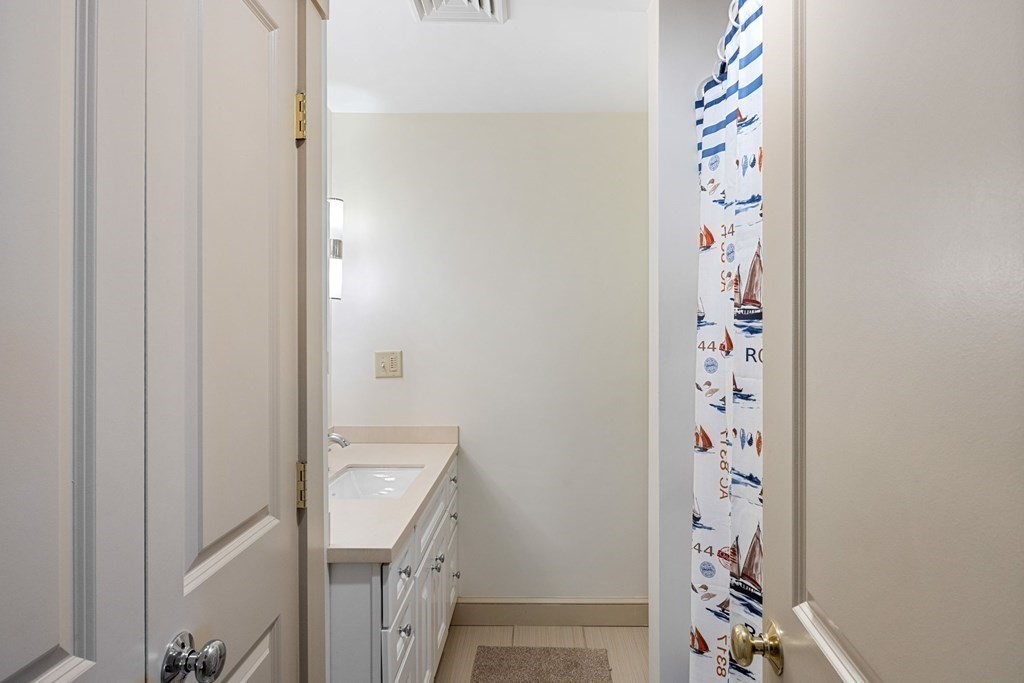 238 Nantasket Road Hull, MA 02045 - Photo 13 of 29 a bathroom with a sink and a shower curtain