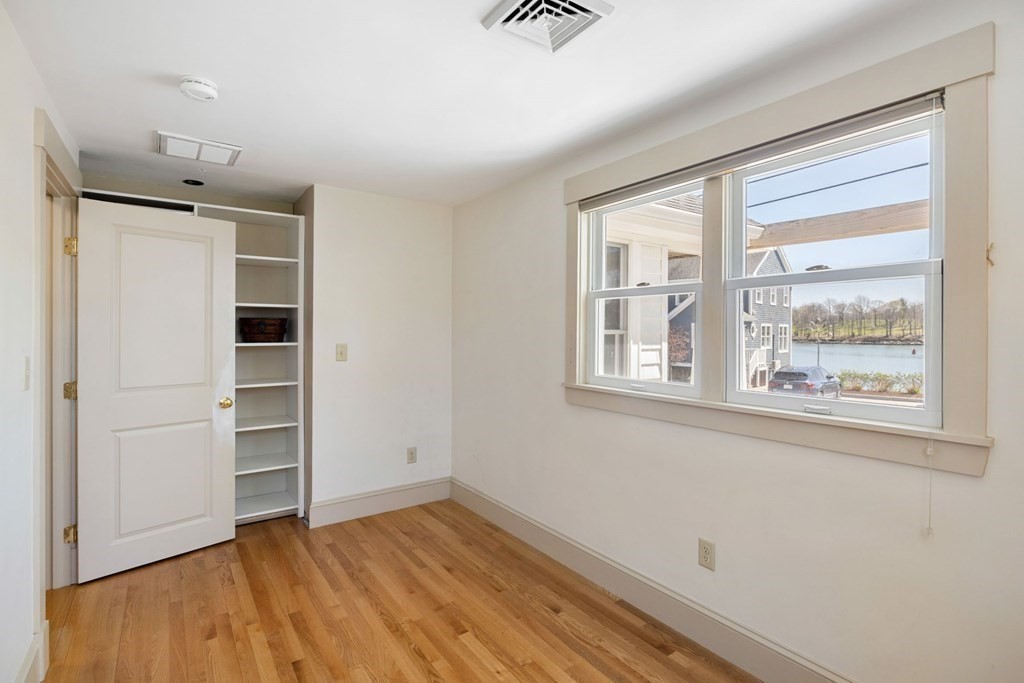 238 Nantasket Road Hull, MA 02045 - Photo 15 of 29 a view of an empty room with a window and wooden floor