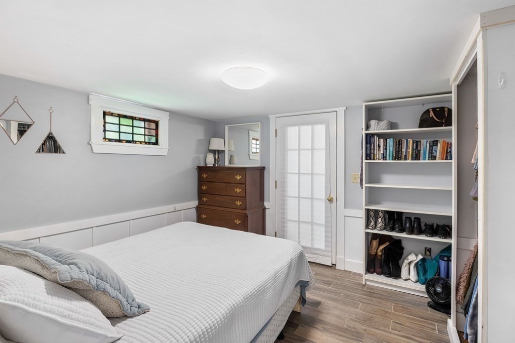 238 Nantasket Road Hull, MA 02045 - Photo 23 of 29 a bedroom with a bed and a book shelf