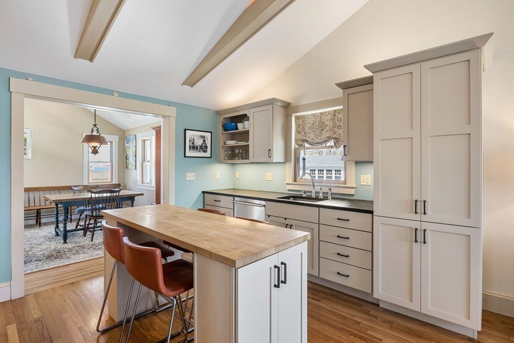238 Nantasket Road Hull, MA 02045 - Photo 8 of 29 a kitchen with granite countertop a stove cabinets and wooden floor