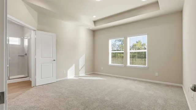 an empty room with windows and closet