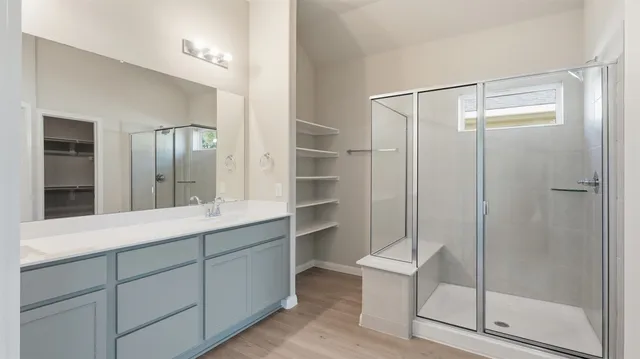 a bathroom with a shower and a sink