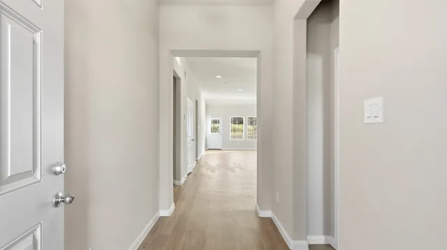 a view of a hallway with a wooden cabinets