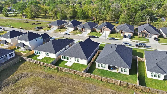 an aerial view of a house with garden space and street view