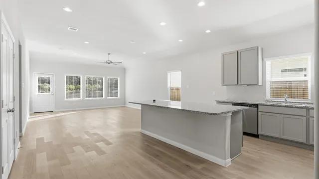 a large kitchen with stainless steel appliances granite countertop a stove and a sink