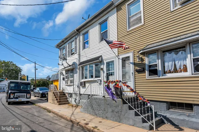 a front view of a house with sitting area