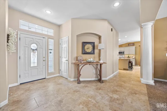 a living room with couches a dining table and chairs with wooden floor
