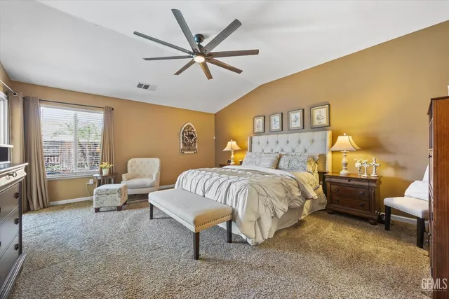 a bedroom with a bed and a lamp