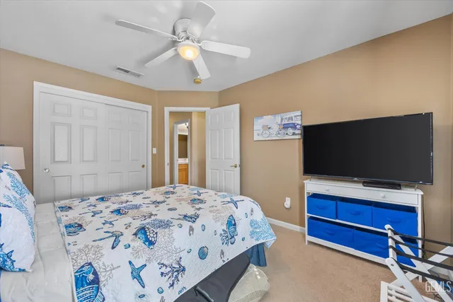 a front view of a house with a yard and potted plants