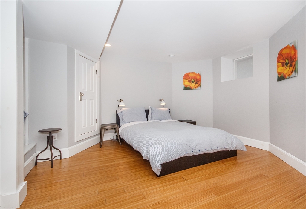 584 Centre Street Boston, MA 02130 - Photo 11 of 29 a bedroom with a bed and wooden floor