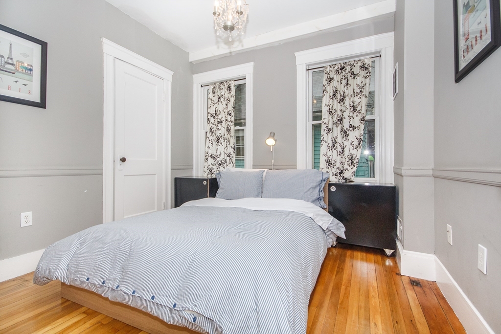 584 Centre Street Boston, MA 02130 - Photo 12 of 29 a bed sitting in a bedroom next to a window