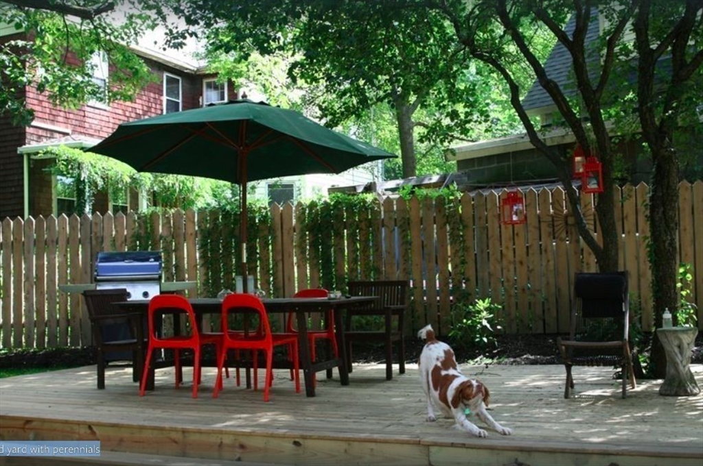 584 Centre Street Boston, MA 02130 - Photo 13 of 29 a view of a table and chairs under an umbrella in patio
