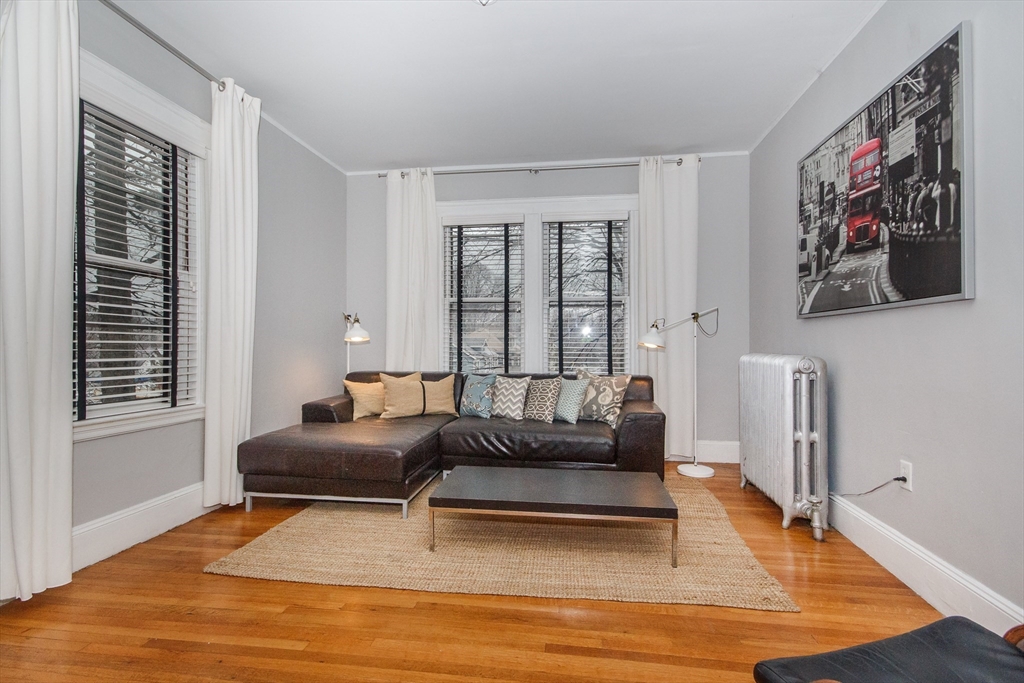 584 Centre Street Boston, MA 02130 - Photo 20 of 29 a living room with furniture and a rug