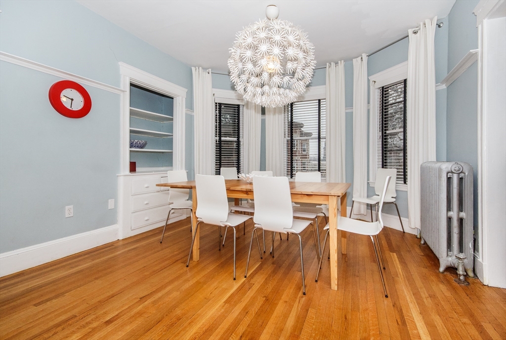 584 Centre Street Boston, MA 02130 - Photo 21 of 29 a view of a dining room with furniture and chandelier