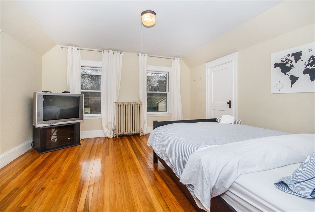 584 Centre Street Boston, MA 02130 - Photo 25 of 29 a bedroom with a bed and a television