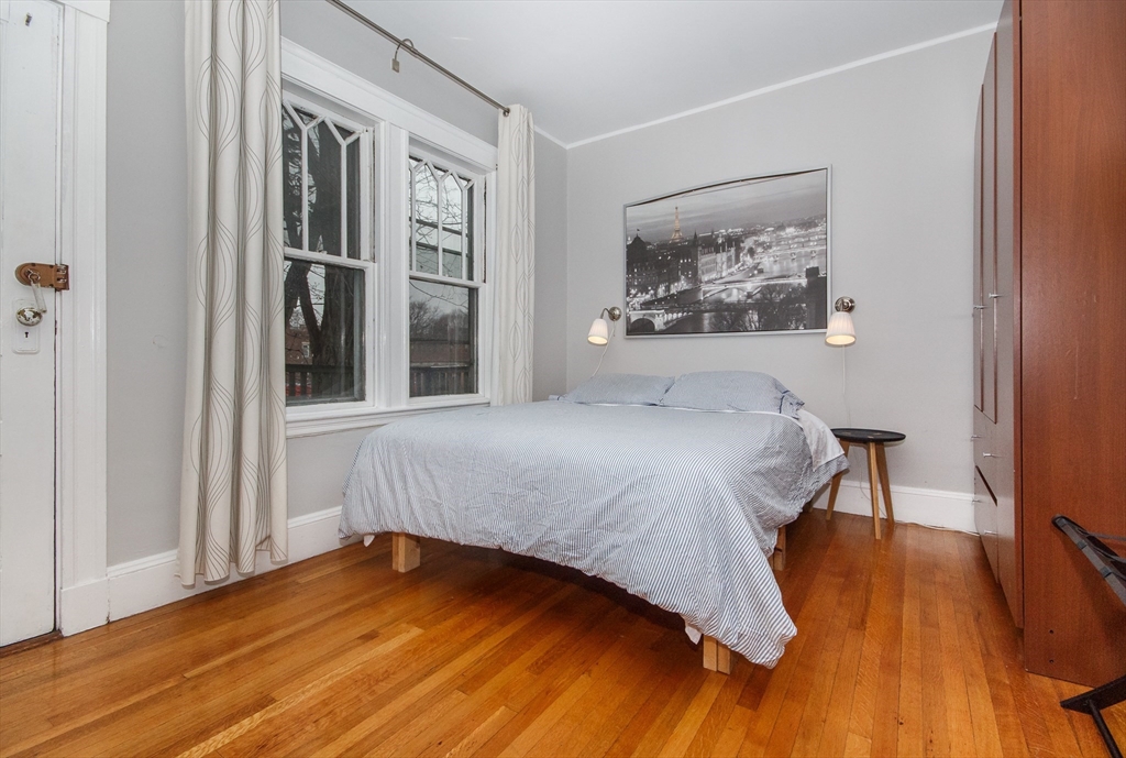 584 Centre Street Boston, MA 02130 - Photo 27 of 29 a bedroom with a bed and a painting on the wall