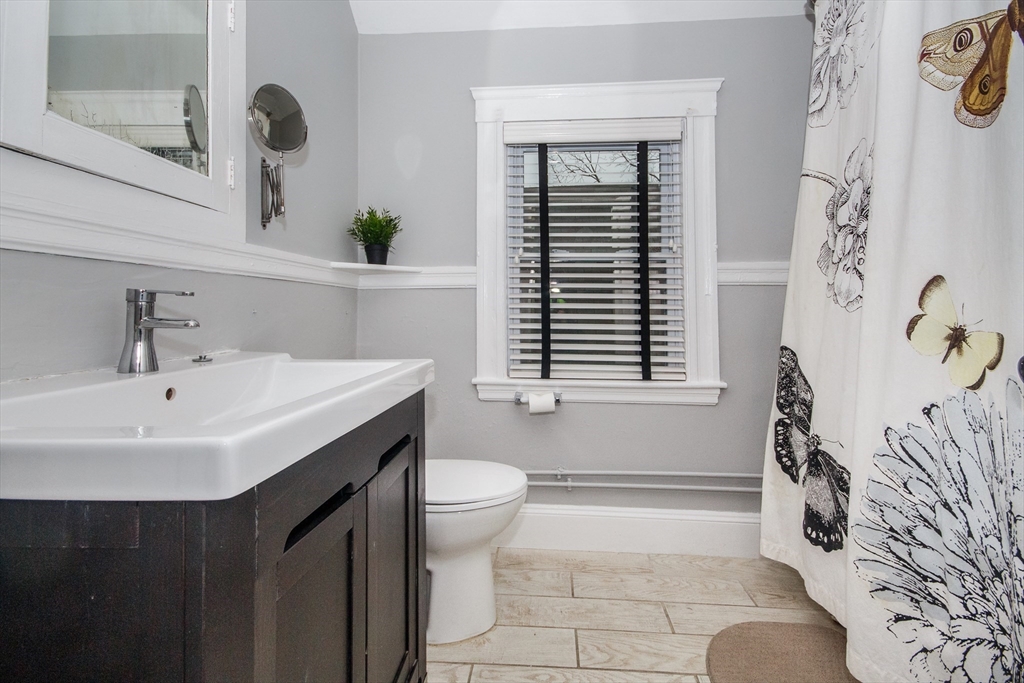 584 Centre Street Boston, MA 02130 - Photo 29 of 29 a bathroom with a sink a toilet and shower