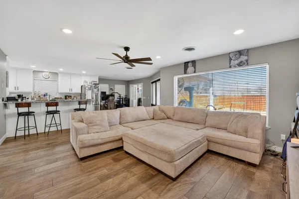 a living room with furniture and a large window