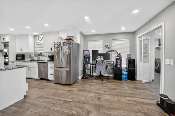 a view of a kitchen and refrigerator