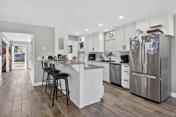 a kitchen with refrigerator and cabinets